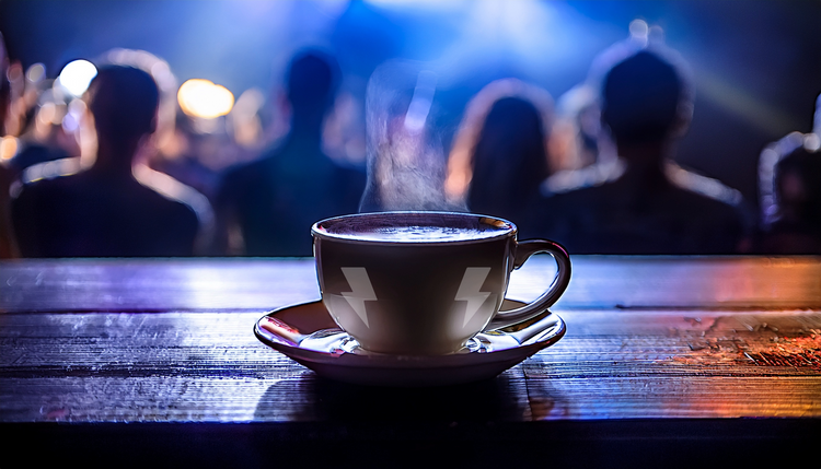 A coffee cup on the main stage of a concert